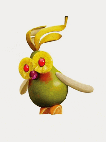 a bird made out of fruit and vegetables including a pear