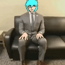 a man in a suit sits on a couch with his hands outstretched