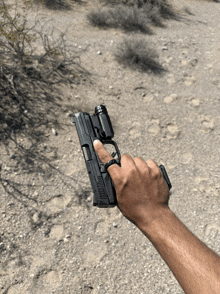 a person holding a gun with a red dot sight