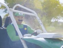 a man in a luigi costume is driving a atv .