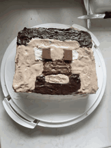 a white plate with a cake on it that looks like a minecraft character