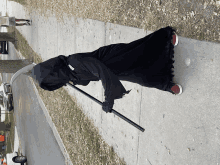 a person dressed in a grim reaper costume holding a large scythe