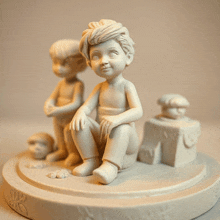 a statue of a boy sitting on a pedestal with two other statues