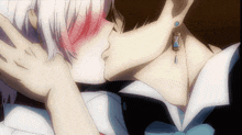 a couple of anime characters kissing with one wearing a blue earring