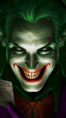 the joker is smiling while holding a joker card .