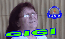 a woman wearing glasses stands in front of a logo for gigi radio