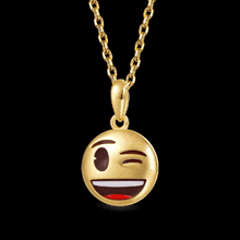 a gold necklace with a smiley face pendant on it