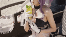 a woman with purple hair and white gloves is sitting on a chair holding a box and a glass