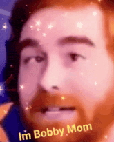a close up of a man 's face with the words im bobby mom written below it