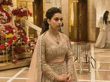 a woman in a dress stands in front of a sign that says fire exit