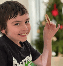 a young boy wearing a black shirt that says ' ntv ' on the front