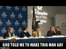 a group of people sitting at a table with a sign that says new hampshire institute of politics in the background