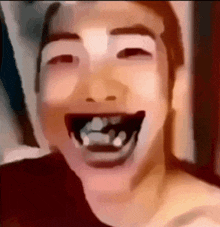 a close up of a person 's face with a big smile on their face