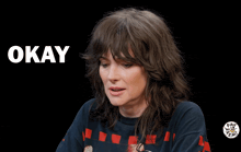 a woman says i 'm okay in a black background