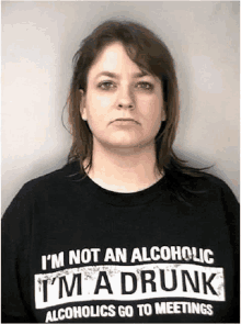 a woman is wearing a black shirt that says i 'm not an alcoholic i 'm a drunk