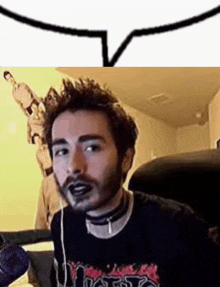 a man with a beard and black lipstick is sitting in a chair with headphones on .