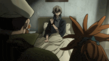 a man in a kimono sits in a bed with a man in a hat standing behind him