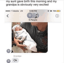 a man is holding a newborn baby in his arms and a text message from grandpa