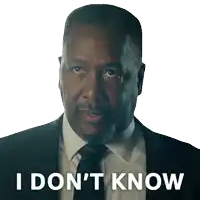 a man in a suit and tie with the words i don 't know below him