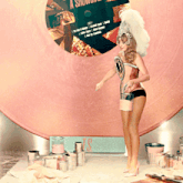 a woman is standing in front of a pink record labeled a showtime