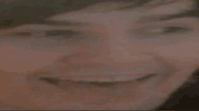 a close up of a person 's face with a smile on it