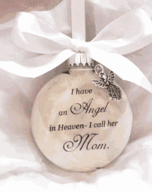 a white ornament that says " i have an angel in heaven - i call her mom "