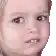 a close up of a baby 's face with a serious look on it .