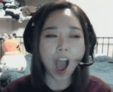 a woman wearing headphones and a microphone yawning