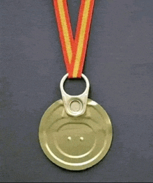 a medal made out of a can lid with a red and yellow ribbon