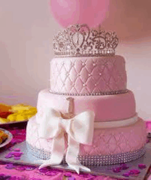 a pink birthday cake with a tiara and a bow on top of it .