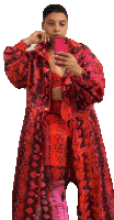 a woman in a red snakeskin coat takes a selfie