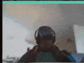 a blurry picture of a man wearing headphones and a hat .