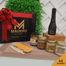 a bottle of freixenet sits on a wooden block next to jars of dip