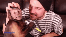 a man petting a small monkey with the word monkey boo visible