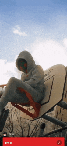 a person in a hoodie is sitting on a basketball hoop with lyrics on the bottom of the screen