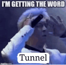 a man is holding a microphone in front of his face and says tunnel