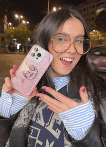 a woman wearing glasses holds a phone case that says ' i love you ' on it