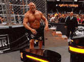 a man with a beard is standing on a table in front of a crowd .