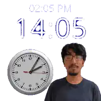 a man with glasses stands in front of a clock that reads 2:05 pm