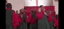 a group of people in red and green robes singing