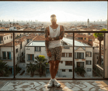 a man standing on a balcony overlooking a city