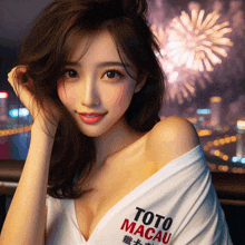 a woman wearing a toto macau shirt stands in front of a fireworks display