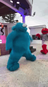 sesame street characters elmo and cookie monster are dancing together