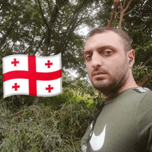 a man wearing a nike shirt stands in front of a flag of georgia