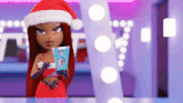 a doll is wearing a santa hat and holding a gift