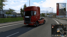 a red scania semi truck is driving down a road