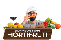 a man in a chef 's hat is eating a carrot in front of a shopping das frutas sign