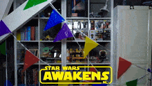 a sign that says star wars awakens in front of a shelf full of toys
