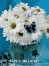 a butterfly is flying over a vase of daisies with the words happy birthday written on the bottom
