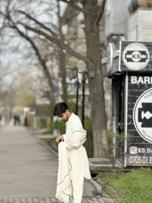 a man standing in front of a kiosk that says ks